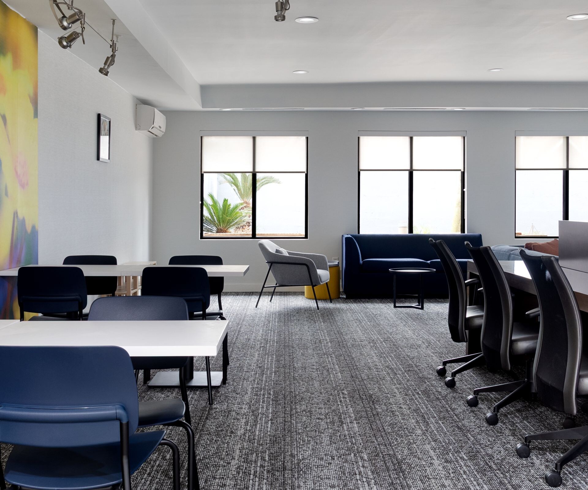 Modern lobby lounge with communal work table.