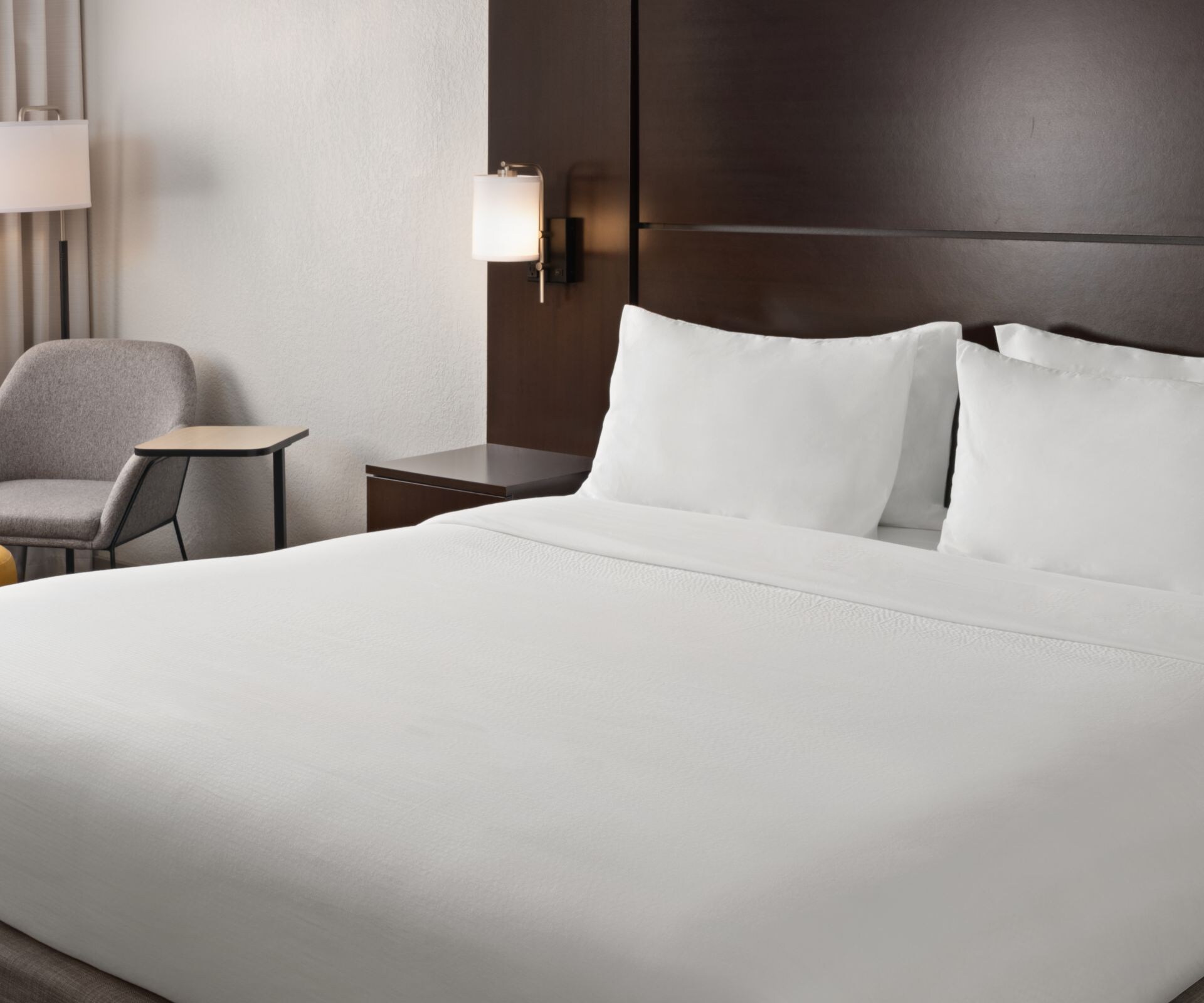 King Bed, plush chair, lamps, window, side tables 