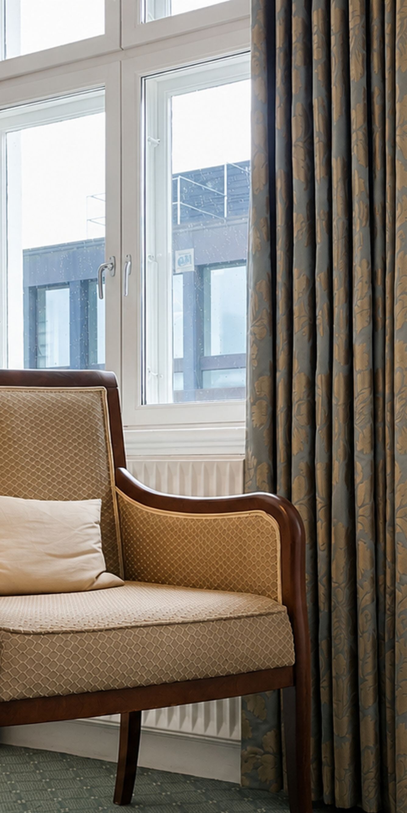 Stol i hjørnet af hotelværelset ved siden af vinduet