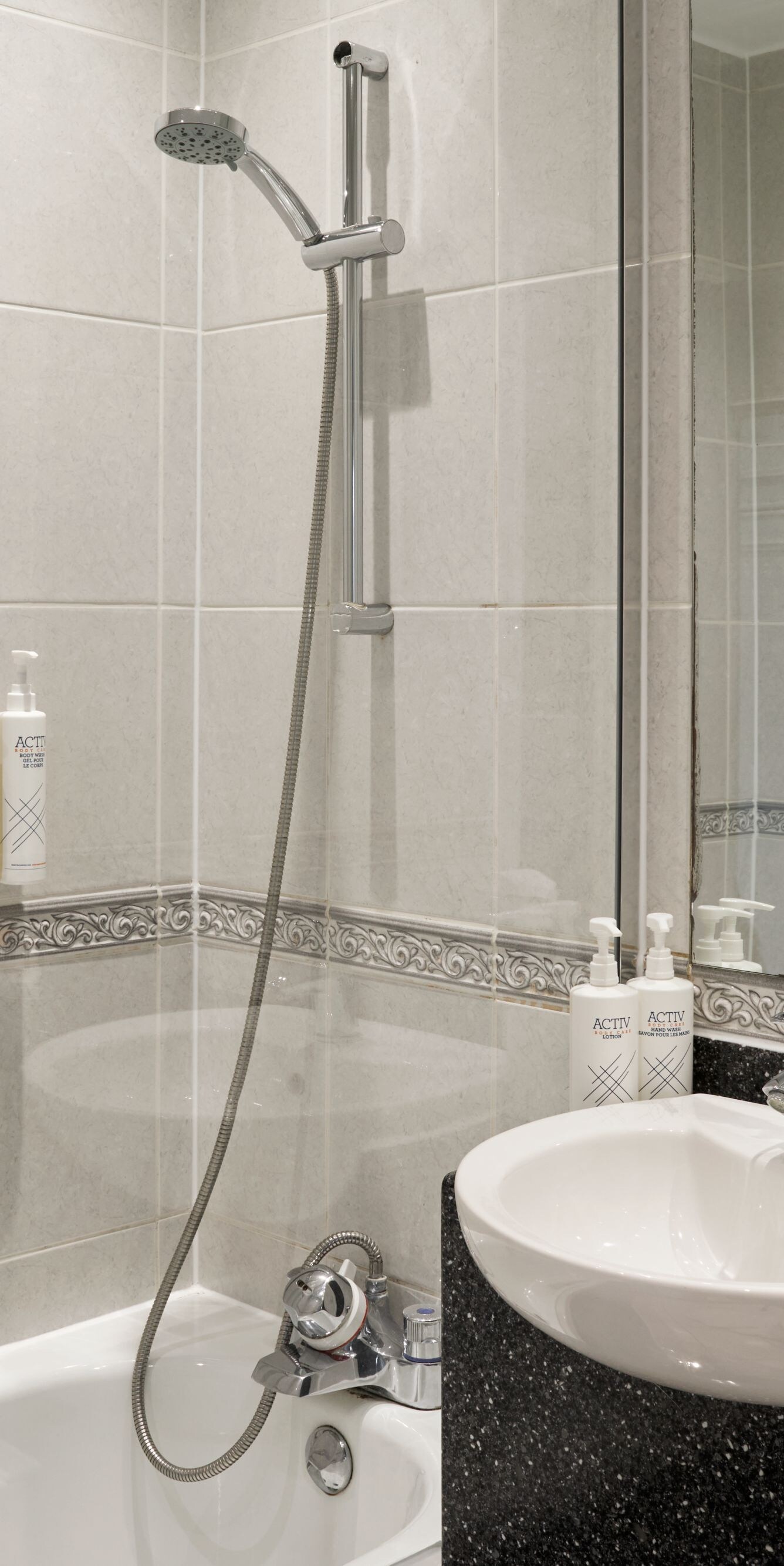 Bath with over head shower and wash hand basin