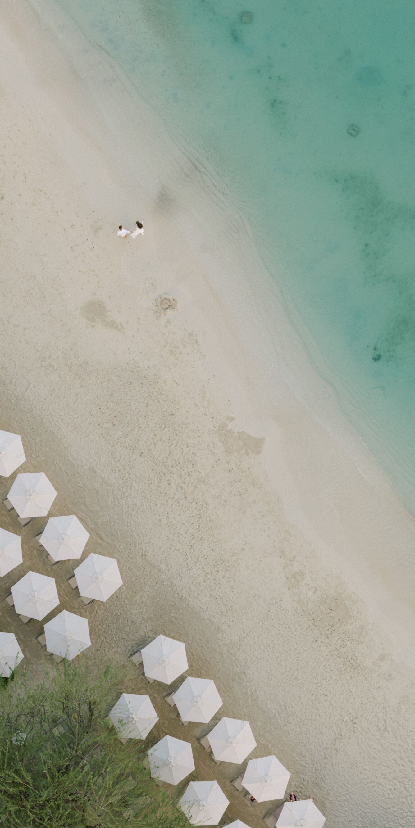 Beach with white umbrellas and turquoise water