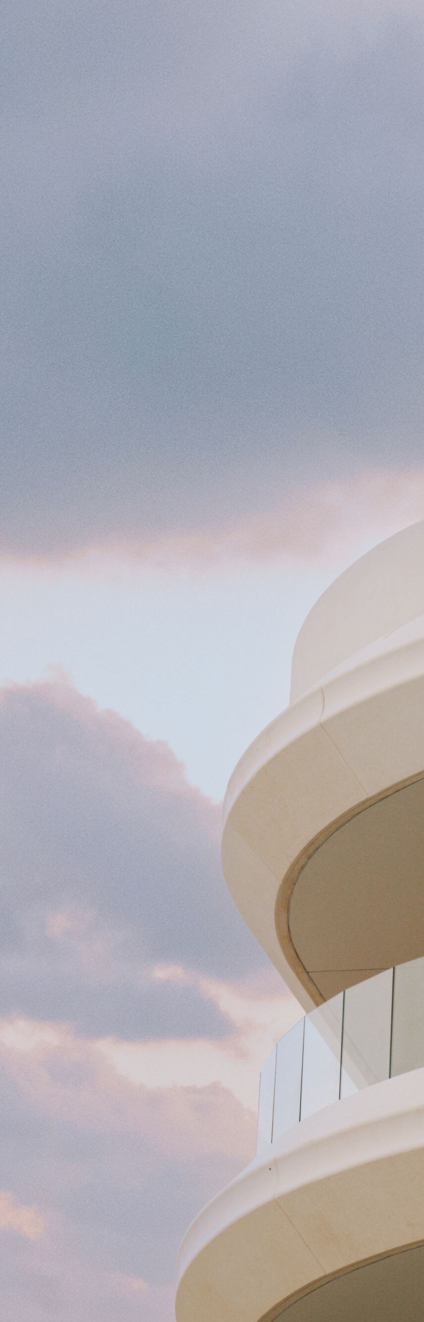 Woman standing on resort's balcony gazing the vie