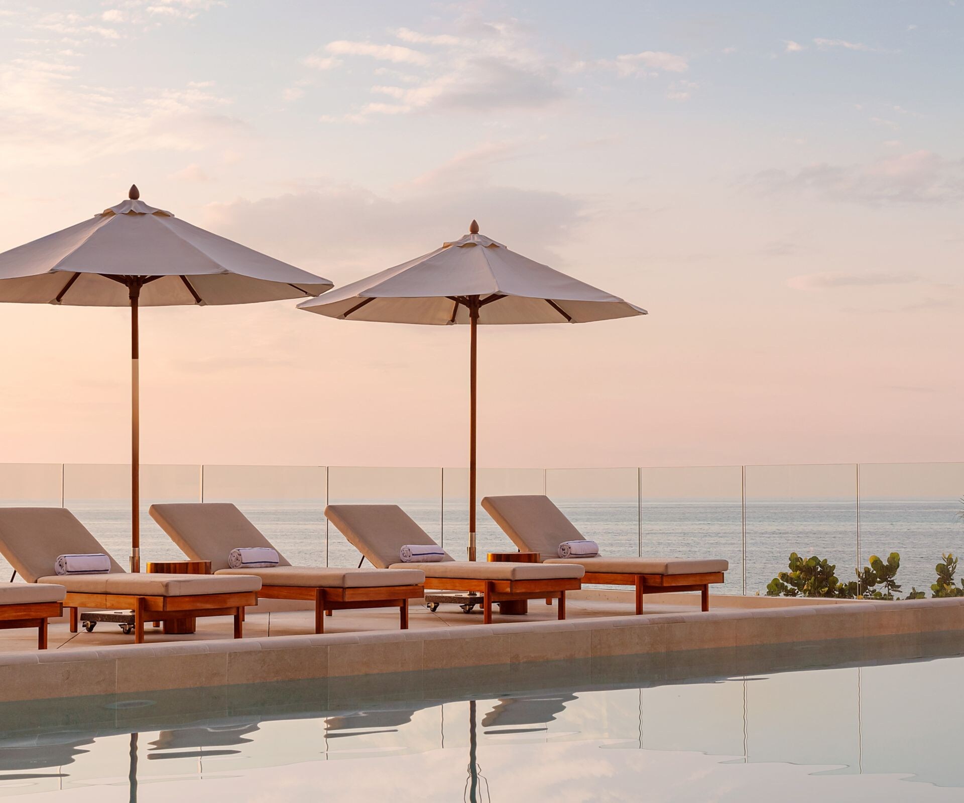pool featuring loungers and umbrellas 