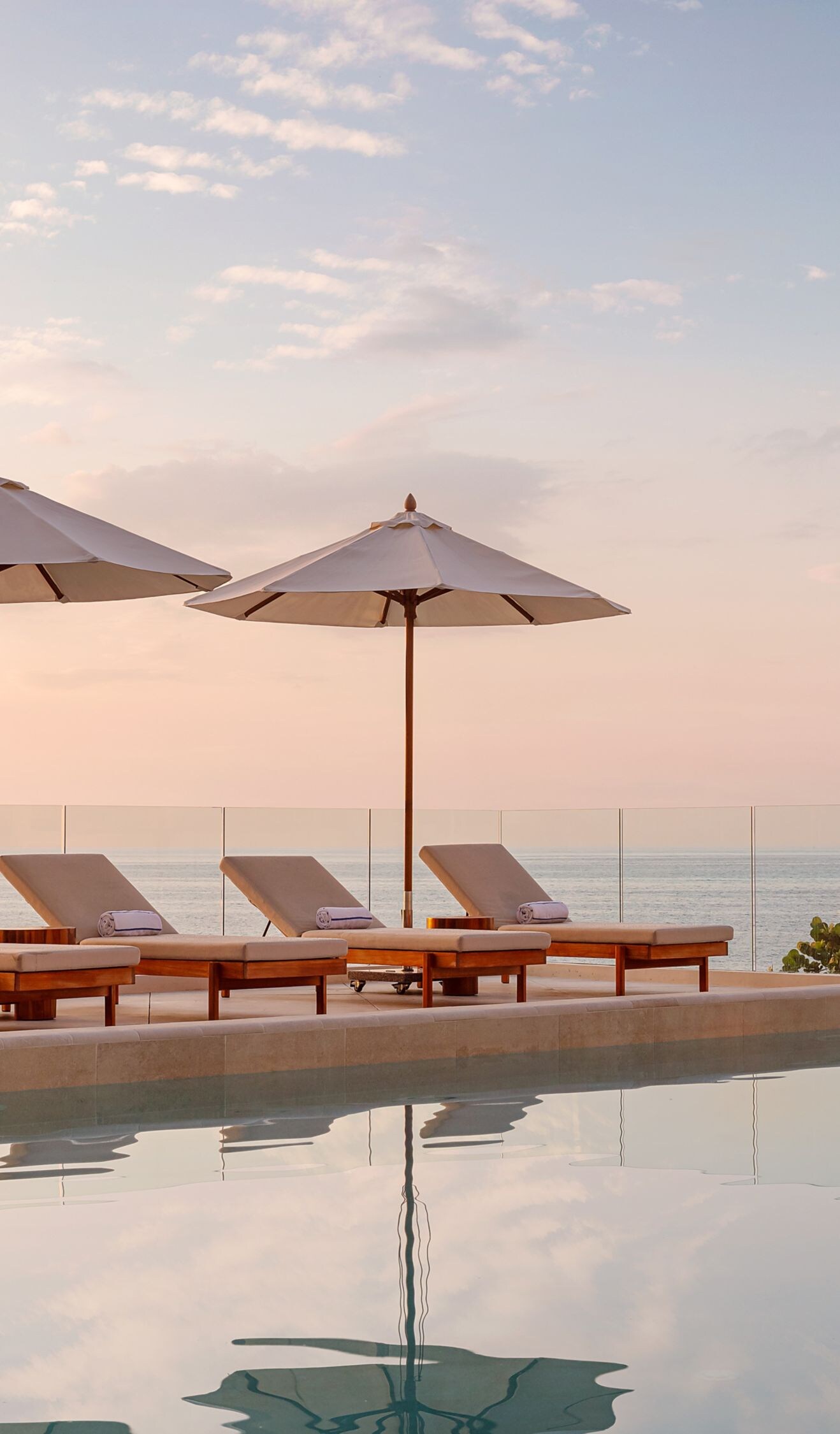 pool featuring loungers and umbrellas 