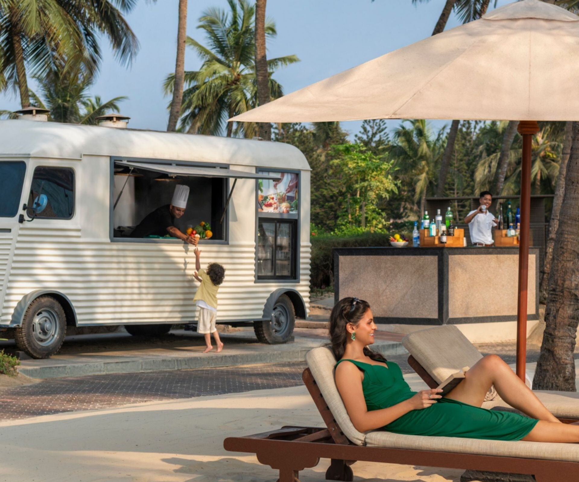 couple lounging under umbrella near food truck