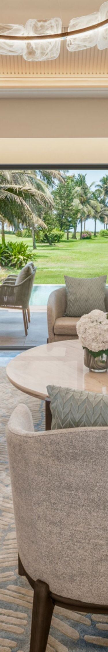 Living room with sofa seating and patio garden 