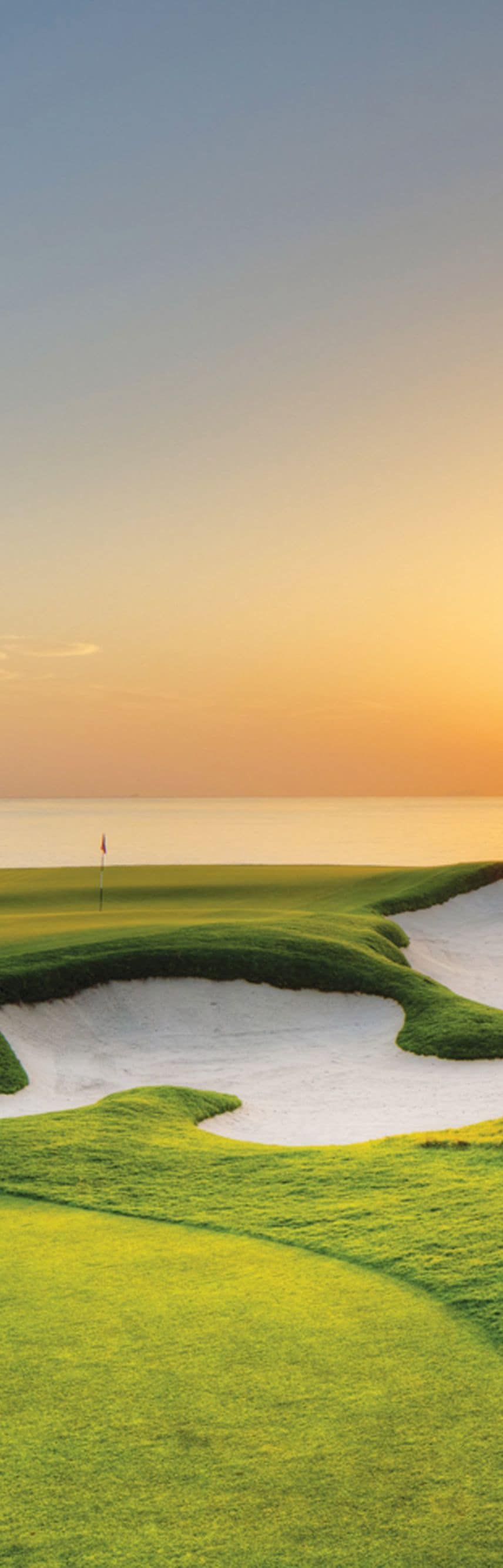 Oceanfront golf hole at sunset
