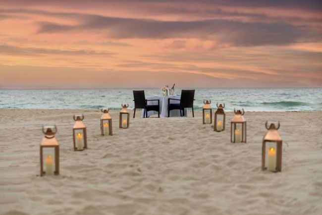 Table on the beach with candlelight, a table and c