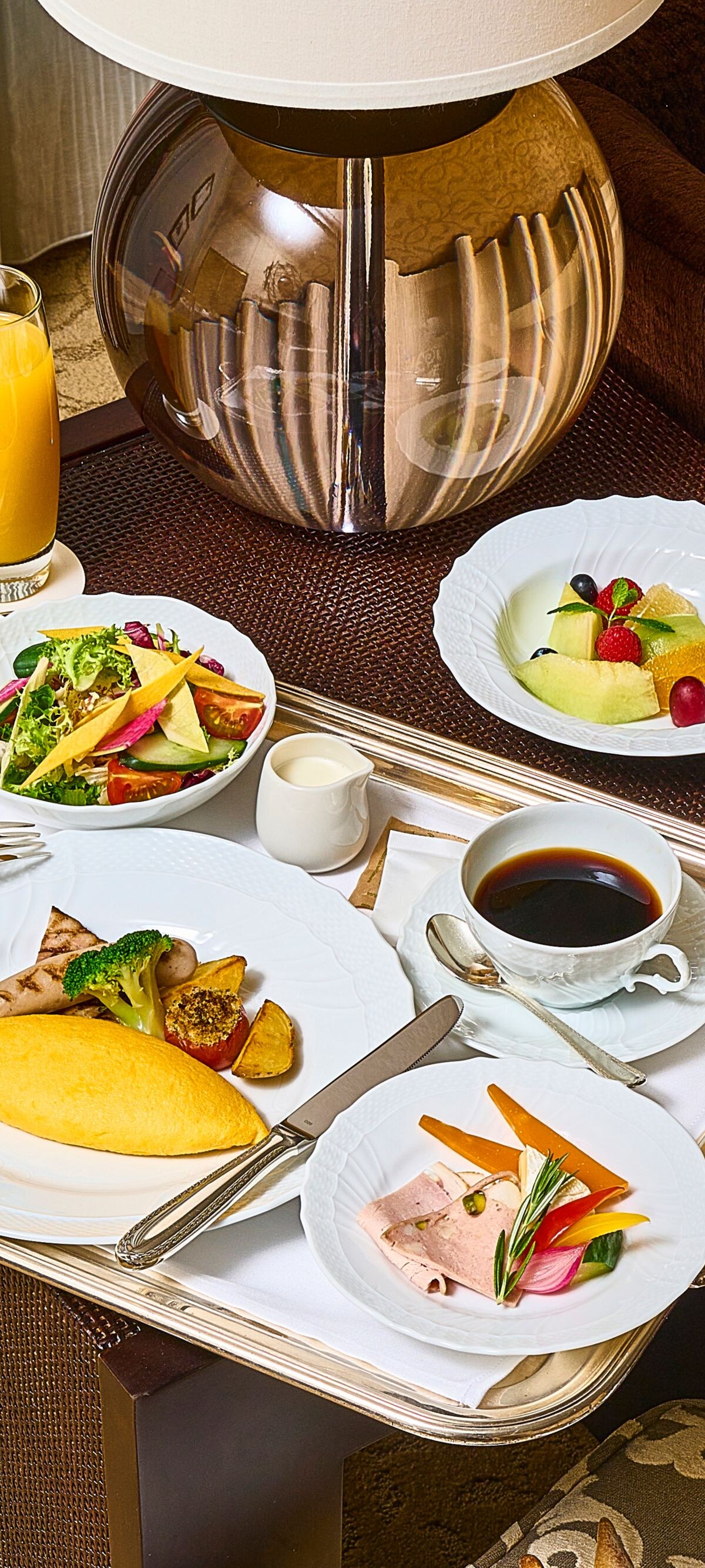 A tray with an omelet and 2 plates of veggies.