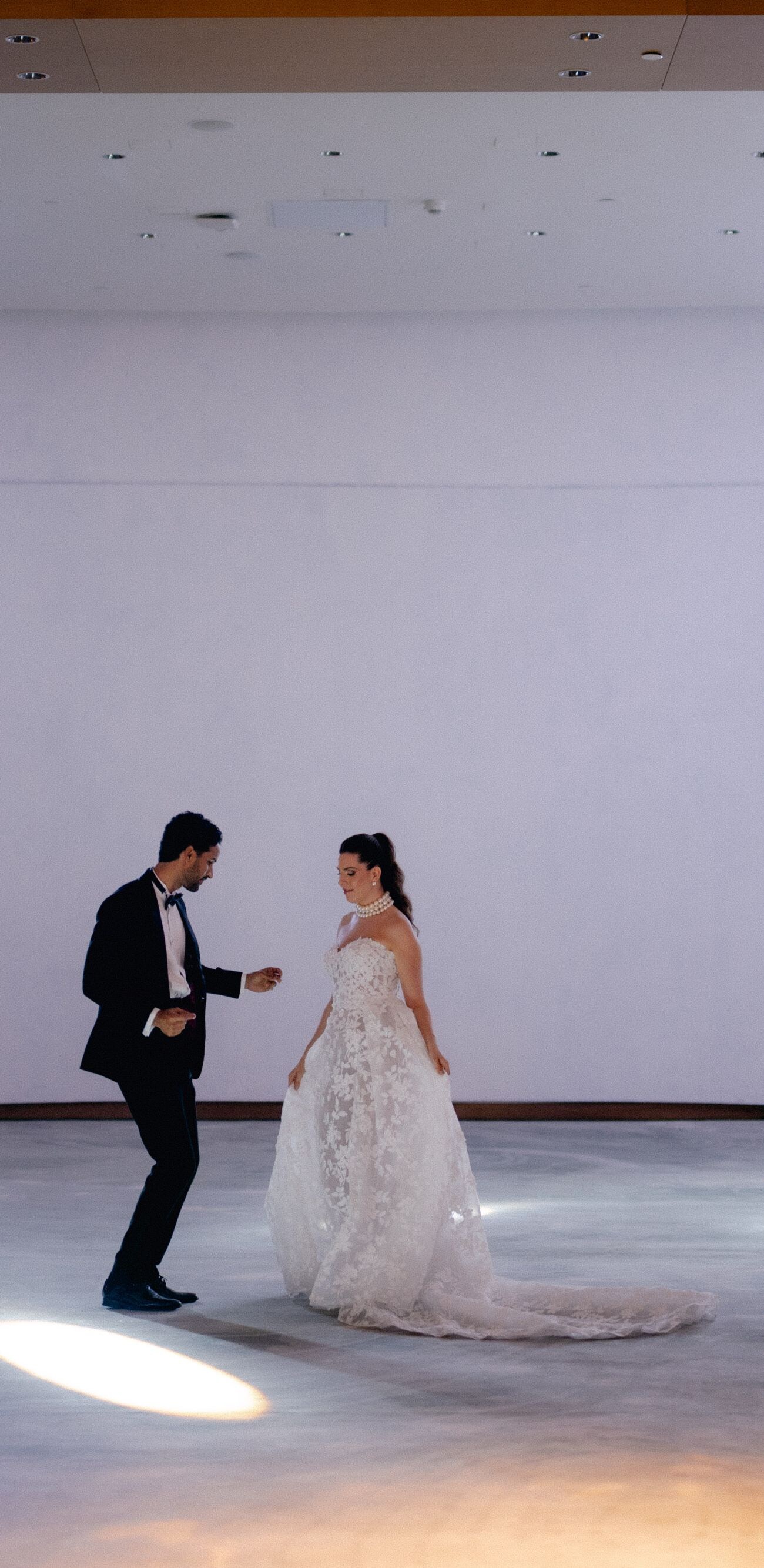  Two people in wedding attire dancing indoors   