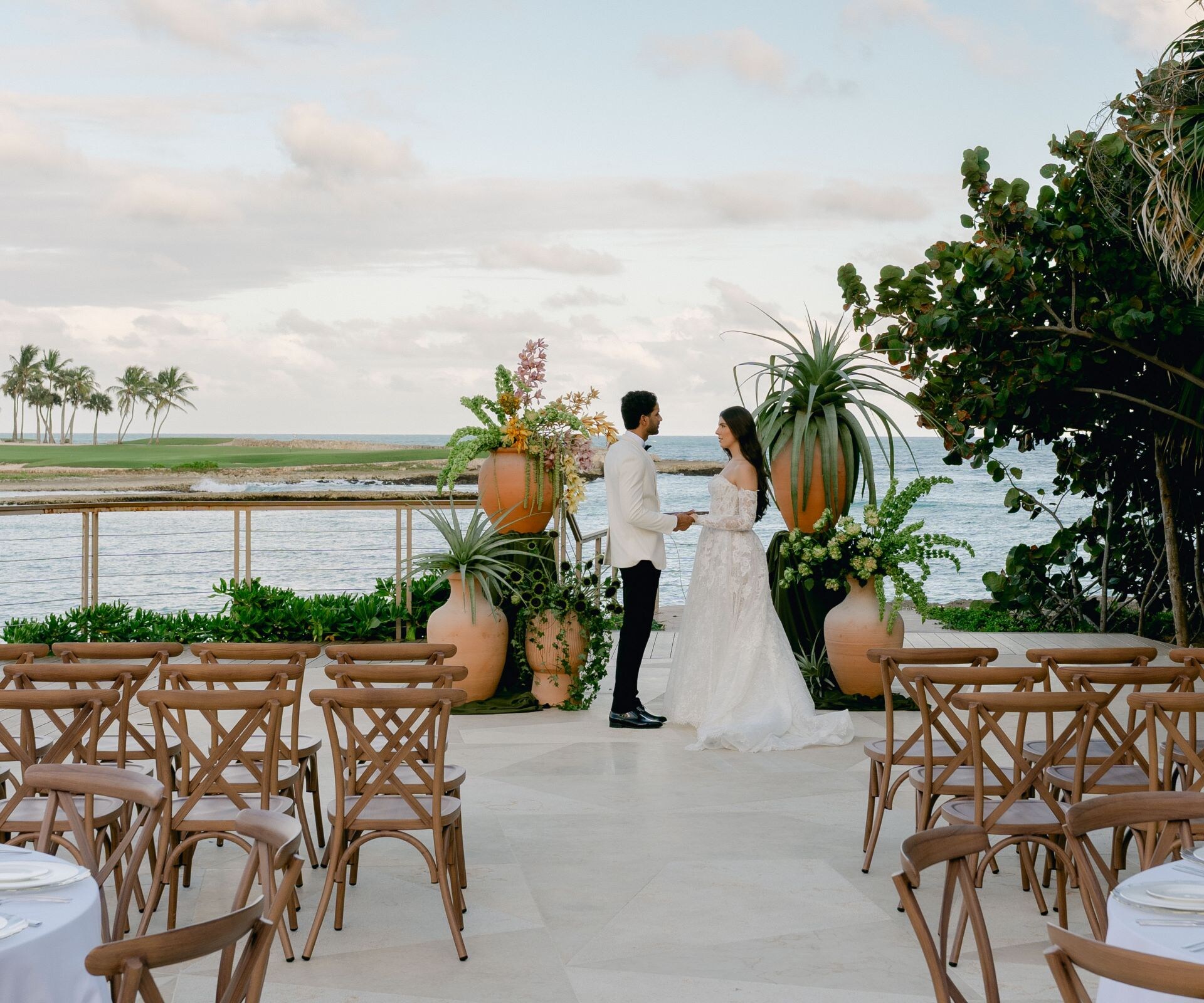 Couple in wedding attire during outdoor ceremony