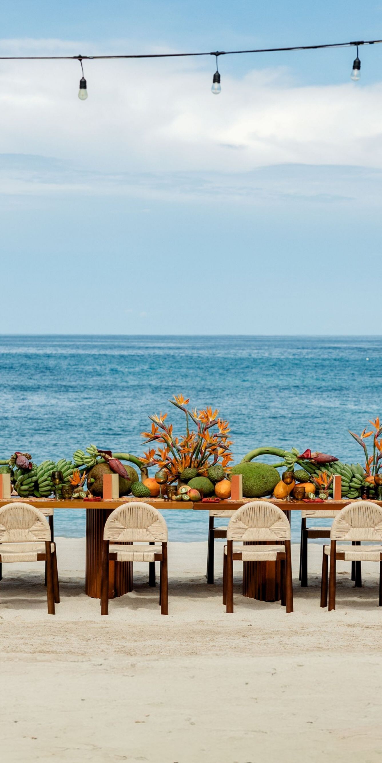 Beachfront dining table with tropical decor