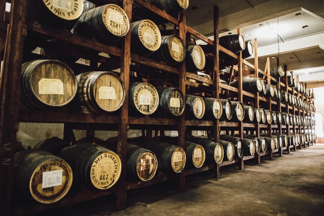 Ron Barrilito Rum barrels stacked in a warehouse.