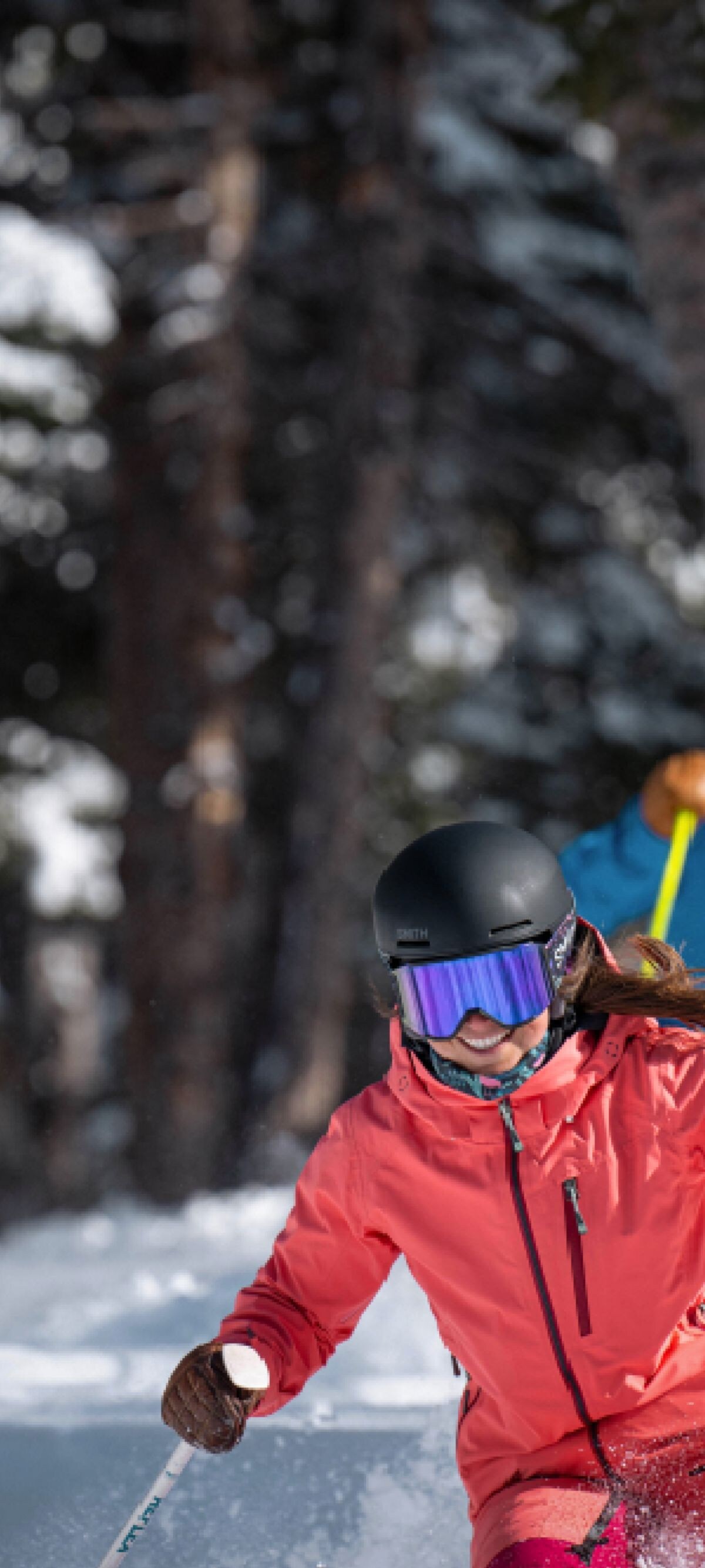 A couple skis down a mountain