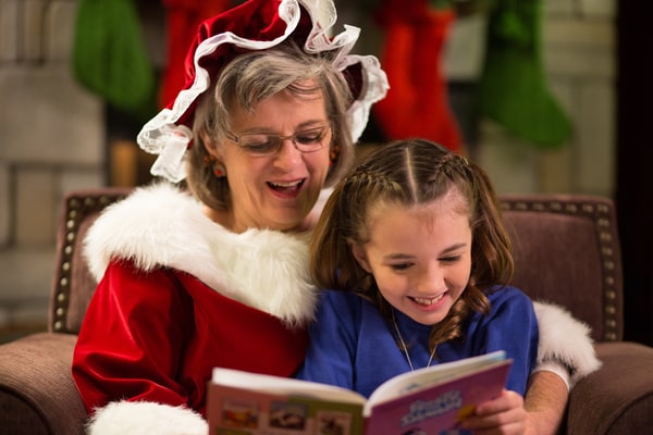Mrs Claus reading to a little girl