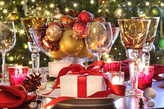 Holiday table setting with gift and wine glasses