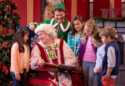 Mrs. Claus, elf and group of young children