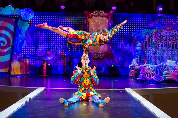 circus performers dressed in colorful costumes