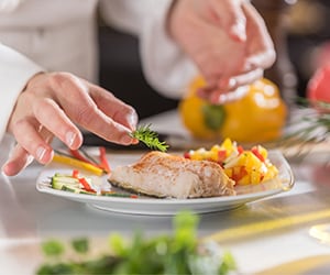 picture of chef's hands preparing dish