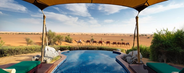 Canopied pool with camel caravan in the distance