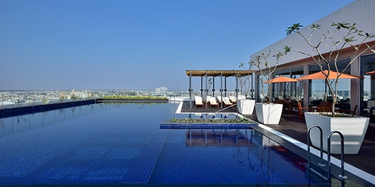 Outdoor pool with cabanas overlooking the city