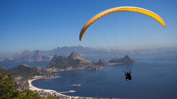 Hang glider soaring over Rio de Janeiro coastline