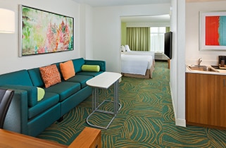 Hotel suite with sofa in foreground and bed in background