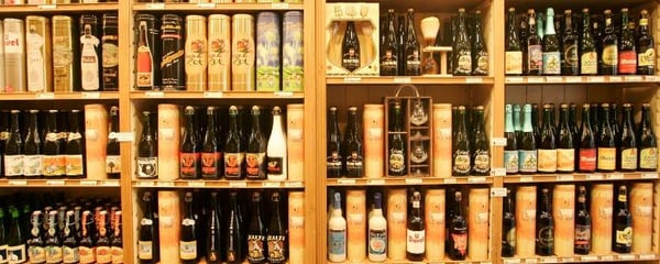 Bottles of Belgian beer in traditional styles line the shelves of a store in Brussels, Belgium