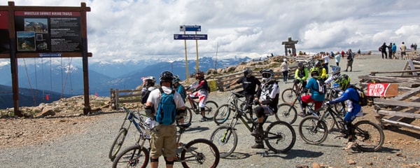 Several bicyclists on the top of Whistler Mountain in Canada.