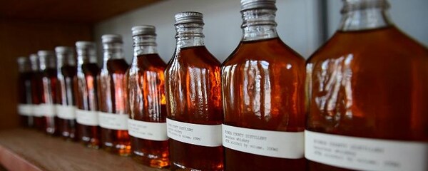 Bottles of whiskey lined up at a distillery in Brooklyn.