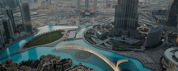 Fountain shoots upward among the skyscrapers in Dubai