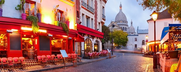 The streets of Montmarte in Paris, France at night.