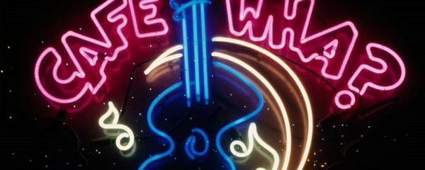A neon cafe sign for a live music venue in New York City.
