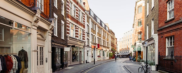 A quiet London street lined with boutiques and shops.