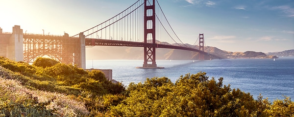 Early morning sun rays light up the Golden Gate Bridge in San Francisco, California