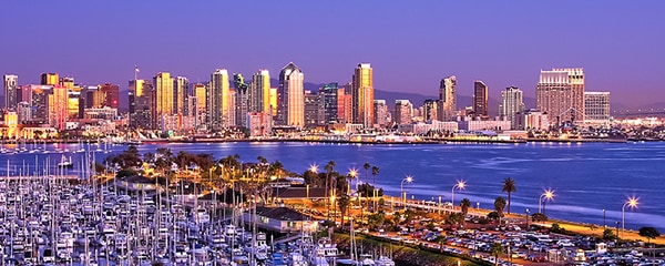 City of San Diego, California rises up along the coast at sundown