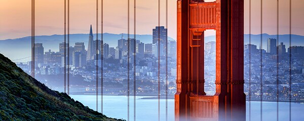 Sunset view of Golden Gate Bridge with San Francisco sitting beyond.