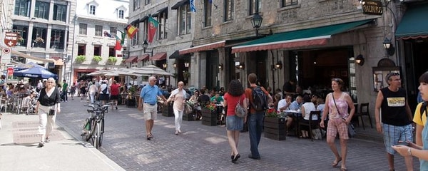 Shoppers walk past restaurants in Montreal near downtown