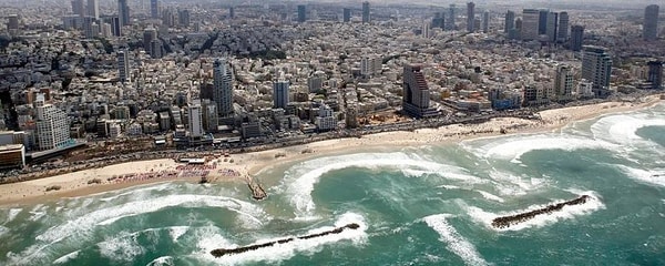 Sea walls catch wave breaks from the Mediterranean off the beach in Tel Aviv, Israel
