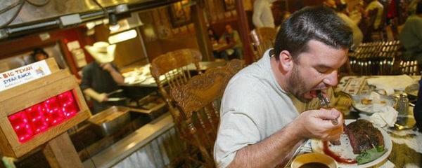 Man enjoys a meal at a steak house restaurant in Cleveland, Ohio