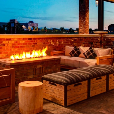 Enjoy the view and cozy seating around our fire pit. The outdoor area with a fire pit is ideal for gathering with friends to relax.