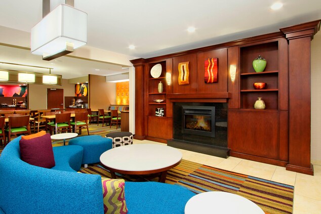 lobby with blue circular couch and fireplace