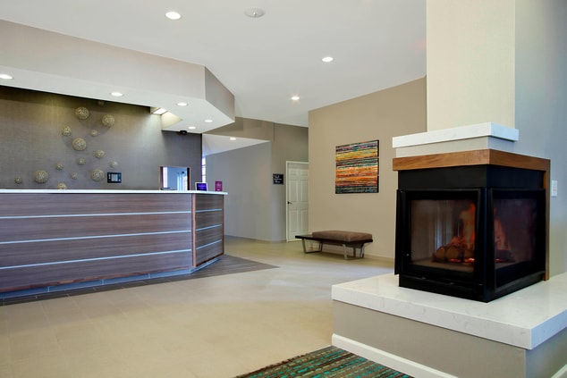 front desk with lobby fireplace