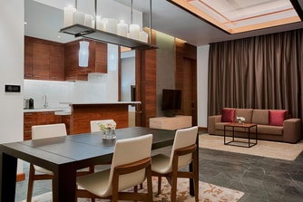 A lavish living area features a large sofa, 55’’ LED Flat screen TV and a dining table to seat six coupled with a functional kitchenette for guests convenience.