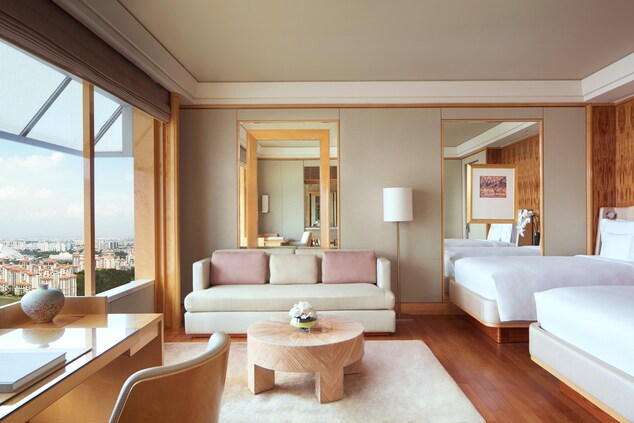 Guest room with two Twin beds and views of the Singapore Sports Hub and Kallang River precinct.