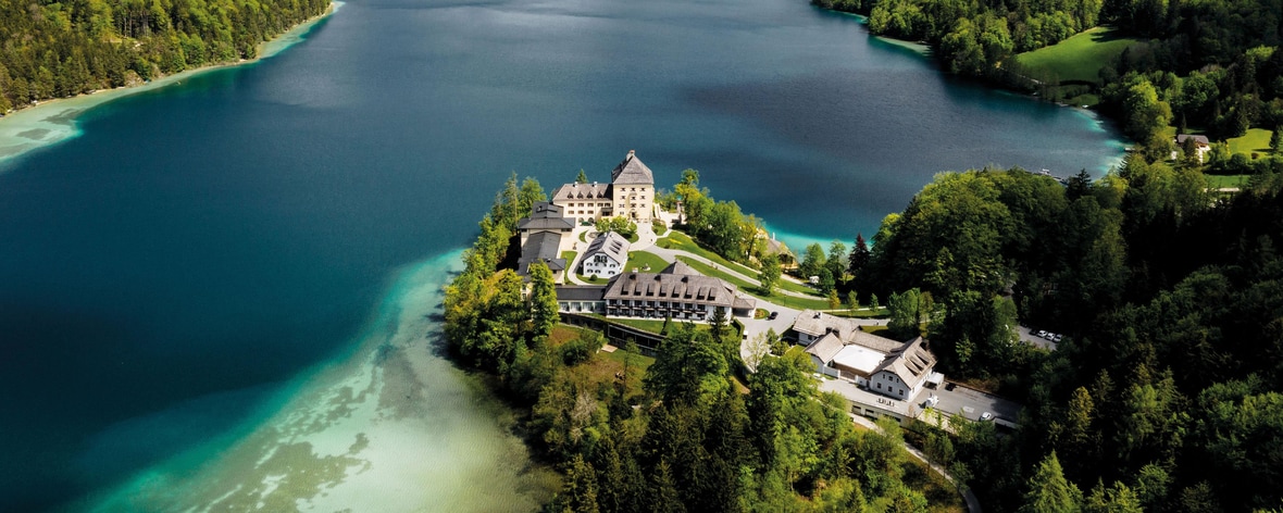 View of the luxury hotel Schloss Fuschl in the middle of the nature of Austria