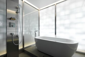 The Bathroom in the Aloft Suite features a soothing bathtub with rainfall shower.